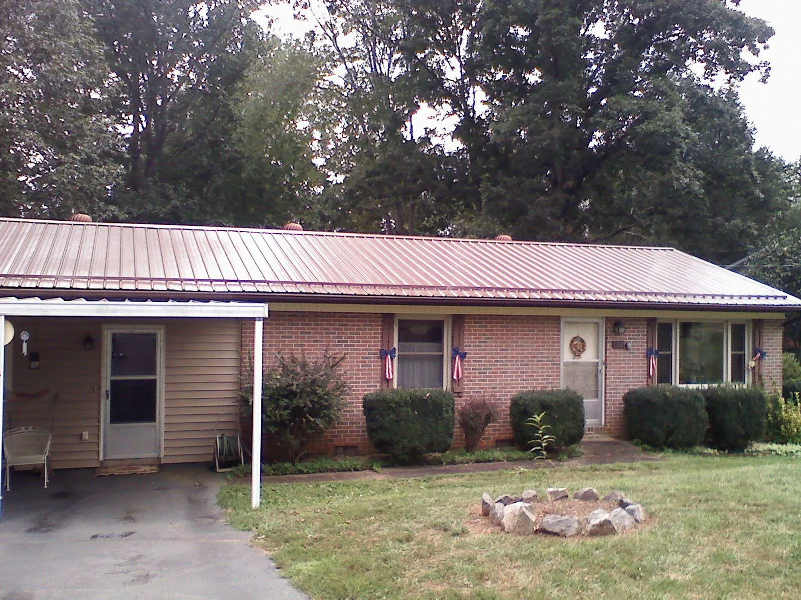 Bronze metal roof and carport on a brick ranch home — Roof Repair work by our crew in Wallingford